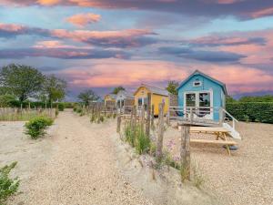 a row of small houses on a beach at Beach Blue in Ellemeet