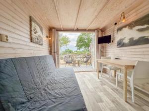 a room with a bed and a desk and a table at Beach Blue in Ellemeet