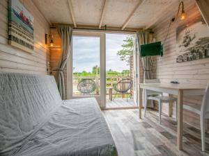 a bedroom with a bed and a desk and a table at Sandy Seven in Ellemeet