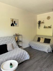 a living room with two beds and a couch at Studio le balcon pied des pistes in Villard-de-Lans