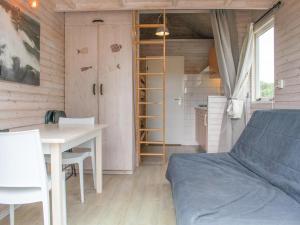 a bedroom with a bed and a desk and a table at Sea Blue in Ellemeet +19 photos