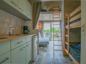 a kitchen with a sink and a bunk bed in a room at Sandy Seven in Ellemeet