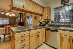 a kitchen with wooden cabinets and a dishwasher at Hibernation Hideaway- Inside Yosemite- Dog Friendly in South Wawona +28 photos