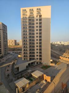 a large white building in the middle of a city at Paradis house in Oran