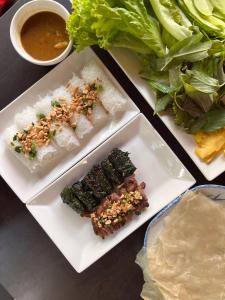 a table with plates of food and a bowl of soup at Haven Nest Retreat in Ấp Phú Hòa (3)