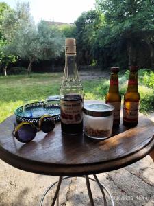 three bottles of beer sitting on a wooden table at Aux Mimosas in La Tour-sur-Orb