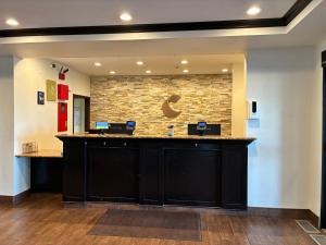 a waiting area at a dental office with a stone wall at Comfort Inn & Suites Sterling in Sterling