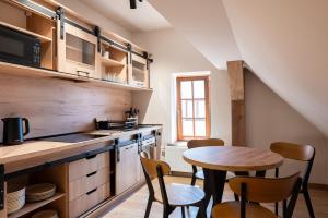 a kitchen with a table and a small table and chairs at Krępianka in Sandomierz