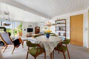 a dining room with a table and some chairs at LF15083-Farso-Illeris-153 in Hole