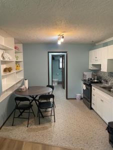 a kitchen with a table and chairs in a room at Zoe house in Victoria