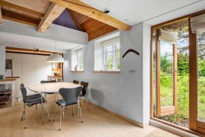 a kitchen and dining room with a table and chairs at FA030-Faxe-Bogebakken-6 in Faxe +17 photos