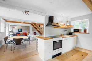 a kitchen and dining room with a table and chairs at FA030-Faxe-Bogebakken-6 in Faxe