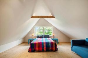 a attic bedroom with a bed and a window at FA030-Faxe-Bogebakken-6 in Faxe