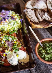 a table with two plates of food and a bowl of dip at Majatalo Puukarin Pysäkki in Nurmes +3 photos