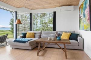 a living room with a couch and a table at LF15163-Hojslev-Jelsevej-163 in Lundø