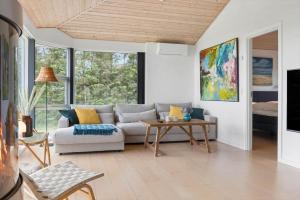 a living room with a couch and a table at LF15163-Hojslev-Jelsevej-163 in Lundø