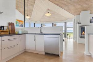 a kitchen with white cabinets and a counter top at LF15163-Hojslev-Jelsevej-163 in Lundø +20 photos