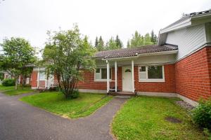 a red brick house with a white door at Aurora Nest in Rovaniemi