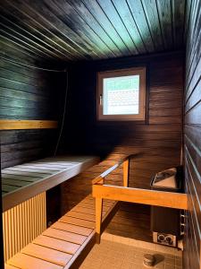 a small sauna with a bench and a window at Aurora Nest in Rovaniemi
