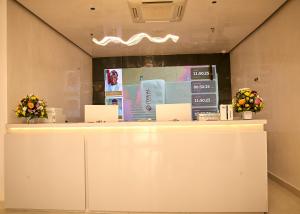 a white counter with flowers on top of it at Treal Hotels & Suites in Abeokuta