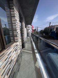 a balcony of a house with a swimming pool at Maddox's Place in São Filipe