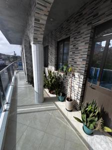 a balcony with potted plants on a building at Maddox's Place in São Filipe