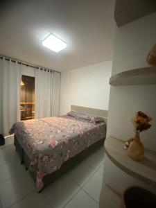 a bedroom with a bed and a vase of flowers at Monte Castelo Flat in Sairé +20 photos