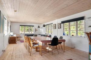 a kitchen and dining room with a table and chairs at 8880-Grenaa-Lyngtoften-49 in Selkær