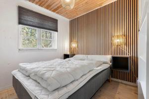 a bedroom with a large bed and a television at 8880-Grenaa-Lyngtoften-49 in Selkær