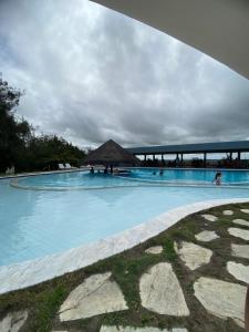 a resort swimming pool with a bridge in the background at Monte Castelo Flat in Sairé