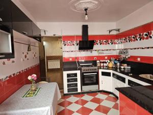 a red and white kitchen with a table in it at Café de Mazagran in Mostaganem +8 photos