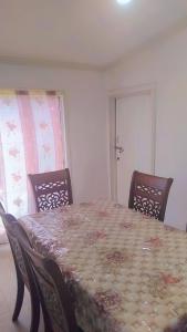 a dining room with a table and four chairs at Nasau Holiday Apartment in Sigatoka