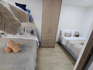 a bedroom with two beds and a stuffed animal on the floor at Casa Central in Cuenca
