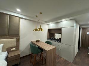 a small kitchen with a table and chairs in a room at Apartment Beach in Itʼkhvisi