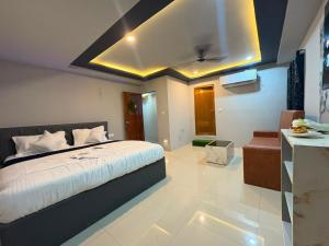 a bedroom with a large bed and a kitchen at HOTELc3 in Visakhapatnam