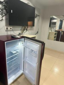 a refrigerator with its door open in a kitchen at HOTELc3 in Visakhapatnam