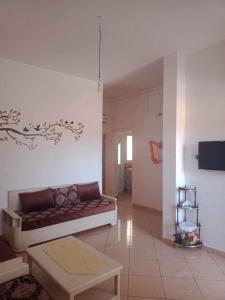 a living room with a couch and a table at Dar Si Lamin 2 in Kelibia