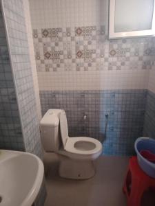 a bathroom with a white toilet and a sink at Dar Si Lamin 2 in Kelibia