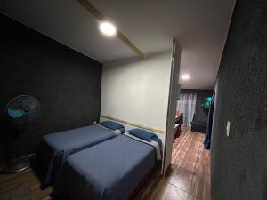 a bedroom with two beds and a lamp in it at EstadiaMalargue in Malargüe