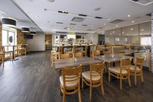 a dining room with wooden tables and chairs at Radisson Hotel Edmonton Airport in Leduc +47 photos