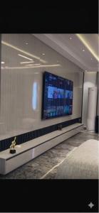 a room with a flat screen tv on a wall at Nikk home in Ado Ekiti