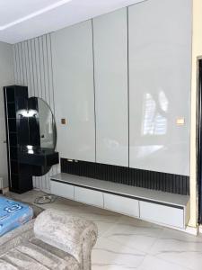 a living room with a tv and a couch at Nikk home in Ado Ekiti
