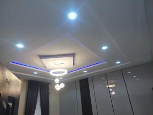 a coffered ceiling with lights in a room at Nikk home in Ado Ekiti