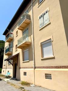 a building with balconies on the side of it at La Rivière Enchantée in Peyraud