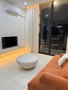 a living room with a couch and a white table at Podium aparment in Kuching