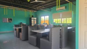 a dining room with blue walls and tables and chairs at mi casa tropical in Hacienda Santa Clara