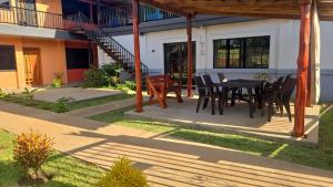 a patio with a table and chairs in front of a building at mi casa tropical in Hacienda Santa Clara