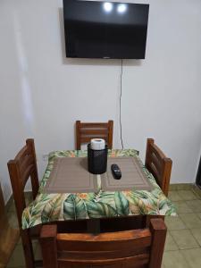 a table with a remote control sitting on top of it at Italia apart departamentos por día con cochera opcional in Corrientes