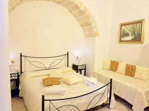 a bedroom with a bed with a cat laying on it at Corte Merlata Apartments in Galatone