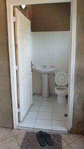 a bathroom with a toilet and a sink at Kiki bay in Conakry